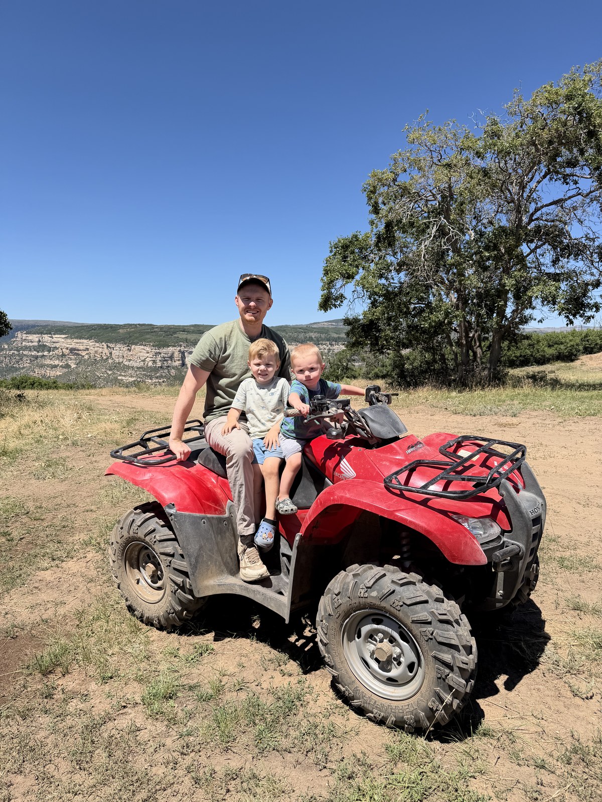 Brayden and his two sons riding an ATV in southern Utah